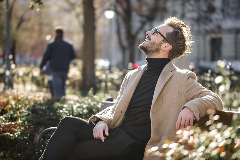 mental health foundation articles mens mental health photograph of happy man sitting on park bench