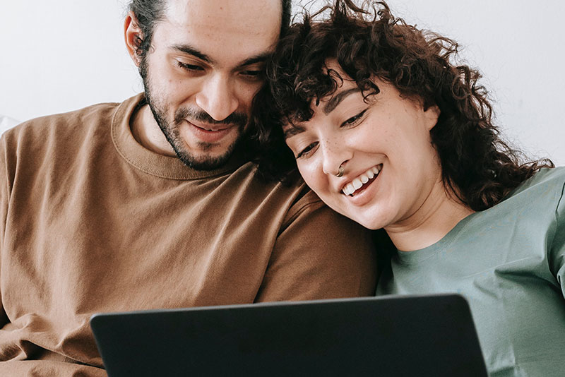 mental health foundation year-end giving close up image of couple using a laptop