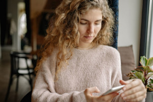 mental health foundation year-end giving image of woman using cell phone