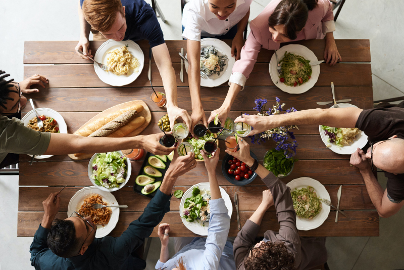 mental health foundation articles loneliness image of a group of friends sharing a meal