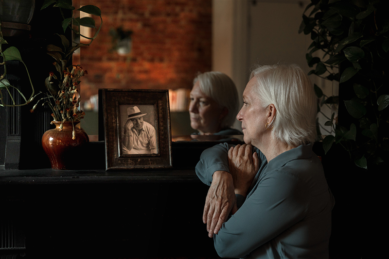 mental health foundation articles loneliness image of a old woman looking at old photo of husband